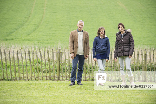 Porträt einer glücklichen Familie auf einem Feld stehend