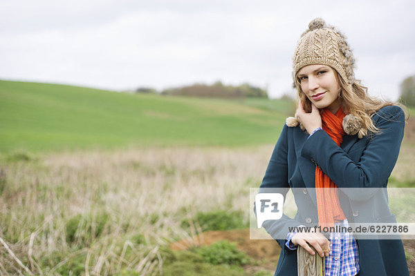 Portrait of a woman standing in a field