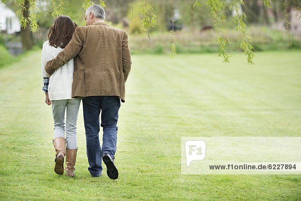 Man walking with his daughter in a park