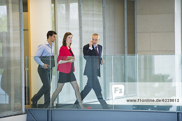 Business executives walking in an office corridor