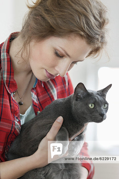 Close-up of a woman holding a black cat