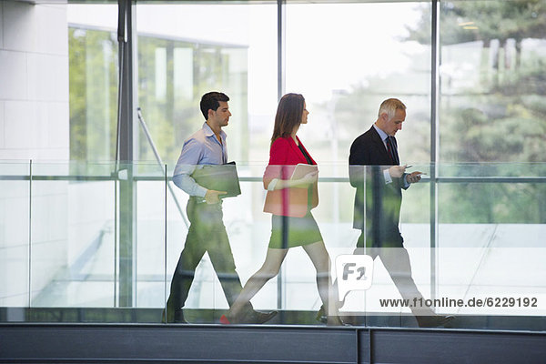 Business executives walking in an office corridor