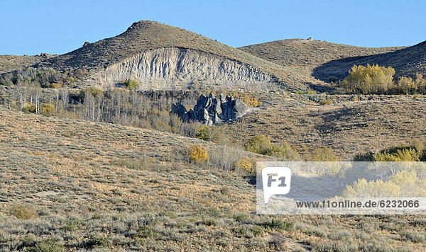 Incision into the landscape  capped hill for a road construction  Highway 20 near Hill City  Idaho  USA