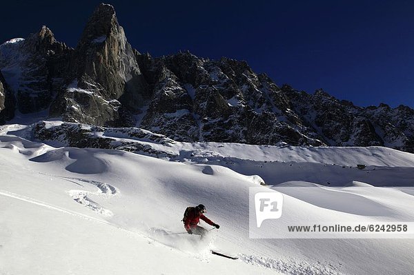 A skier enjoying perfect powder snow on the celebrated Pas de Chevre off-piste run  with the Dru in the background  Chamonix Valley  Chamonix  Haute Savoie  French Alps  France  Europe