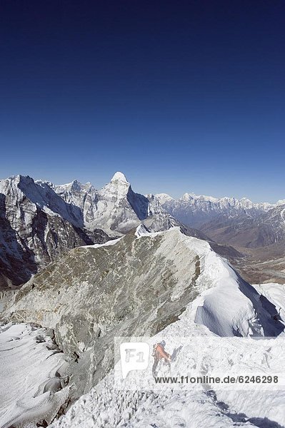 Climber on summit ridge of Island Peak  6189m  Ama Dablam  6812m  Solu Khumbu Everest Region  Sagarmatha 0tio0l Park  Himalayas  Nepal  Asia