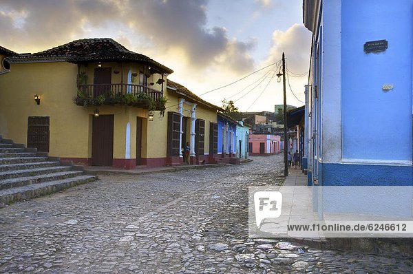 Cobbled street at dusk with brightly painted houses  off Plaza Mayor  Trinidad  Cuba  West Indies  Central America