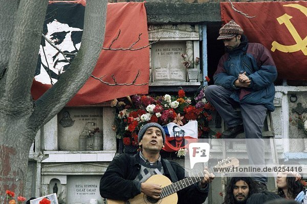 Guitarist plays Victor Jara songs at his grave on 11th de Septiembre  remembering Victor Jara whose hands were cut off in the National Stadium and who was then killed during the Pinochet regime  Santiago  Chile  South America