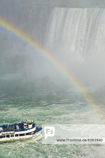 Maid of the Mist tour excursion boat under the Horseshoe Falls waterfall with rainbow at Niagara Falls  Ontario  Ca0da  North America