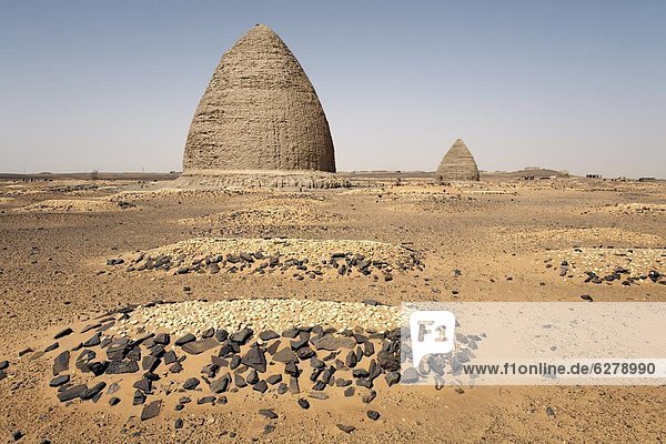 Graves including beehive graves (Tholos tombs) in the desert near the ruins of the medieval city of Old Dongola Sudan Africa