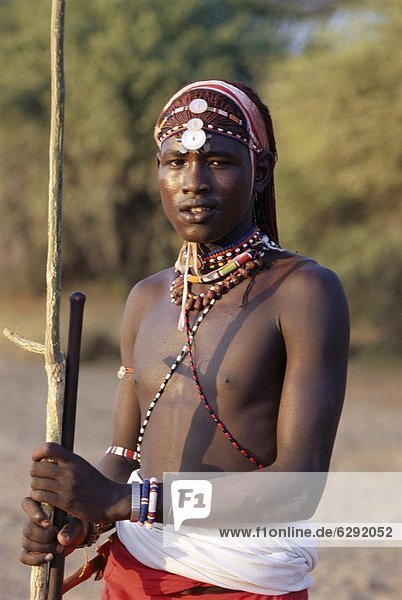 Young Masai morani or warrior with henna-ed hair and beadwork  Laikipia  Kenya  East Africa  Africa