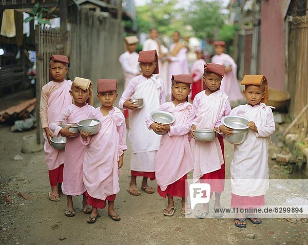 Young nuns with begging bowls  Mandalay  Myanmar  Asia