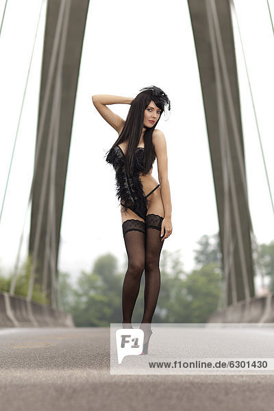 Young woman in black lingerie by La Perla posing on a bridge  Root near Lucerne  Switzerland  Europe