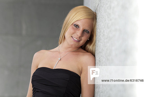 Smiling young woman wearing a strapless top  portrait