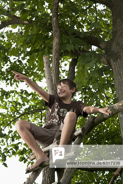 Boy sitting at a tree house