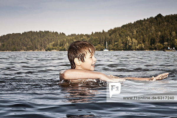 Boy swimming in a lake