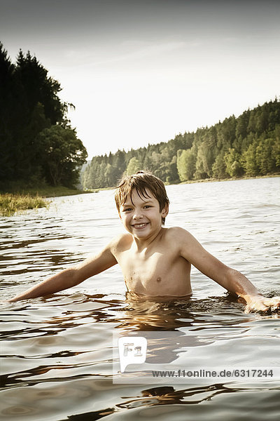 Boy bathing in a lake