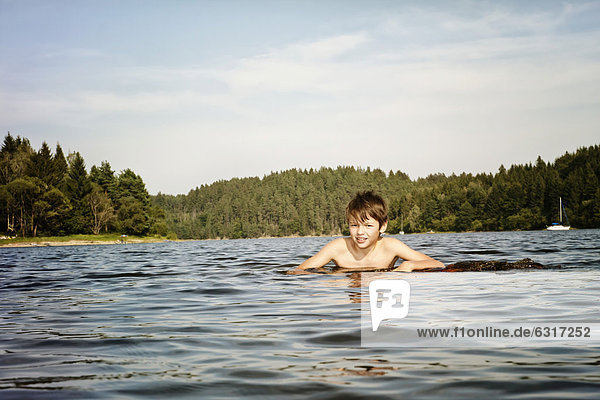 Boy swimming in a lake