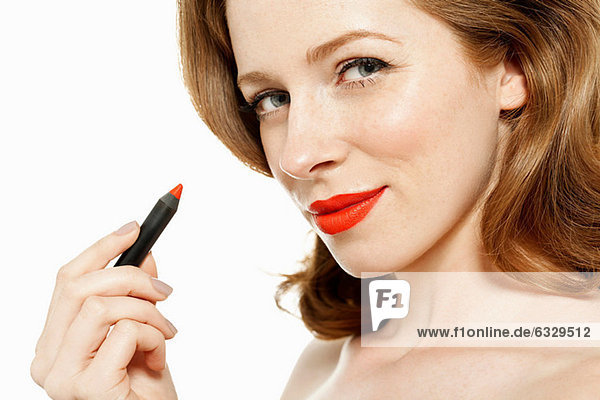 Woman holding red lipstick
