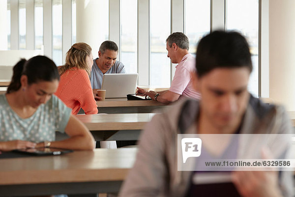Mature students using laptop