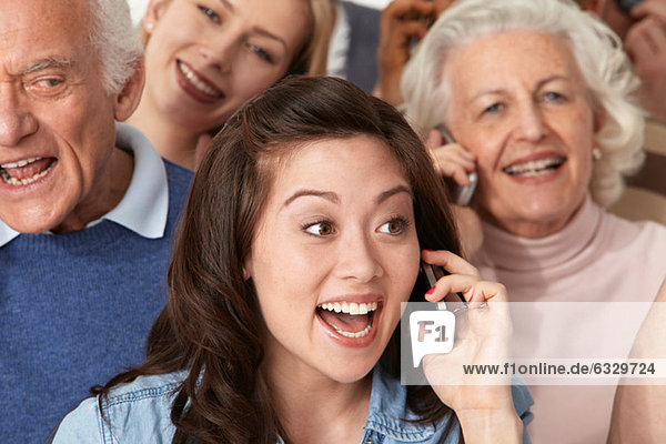 Woman on cell phone with group of people