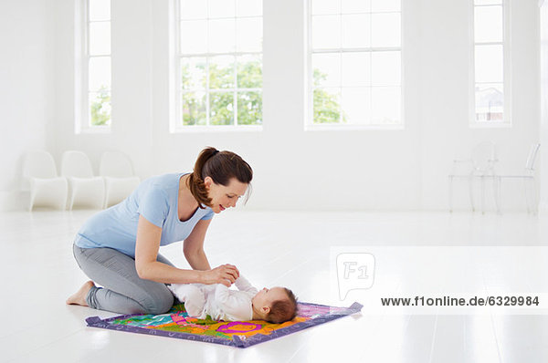 Mother and baby on play mat
