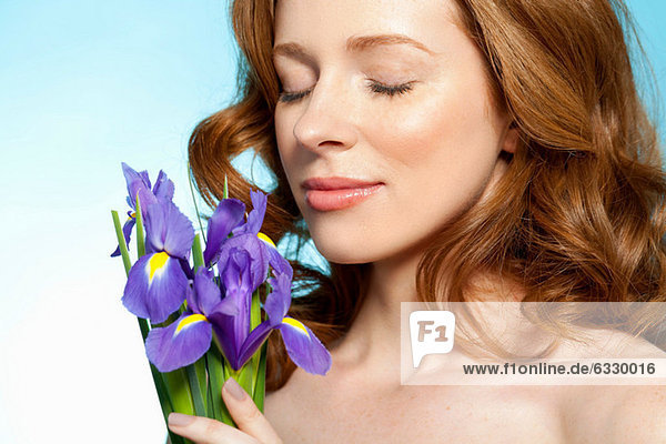 Woman smelling purple flowers