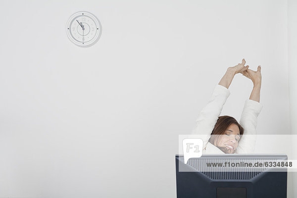 Businesswoman stretching arms