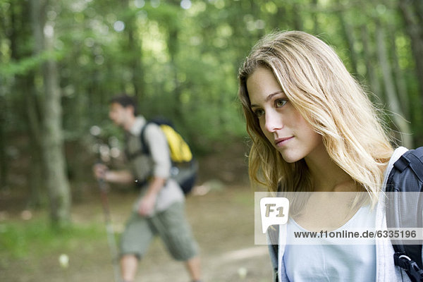 Young woman hiking in woods