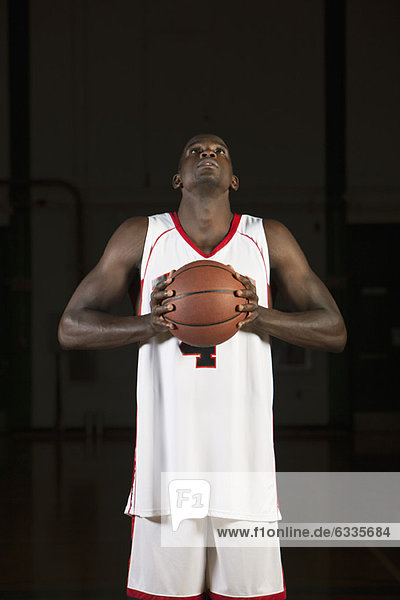 Basketball player holding basketball  portrait