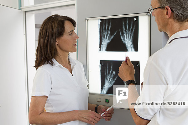 Doctor and nurse examining x-rays