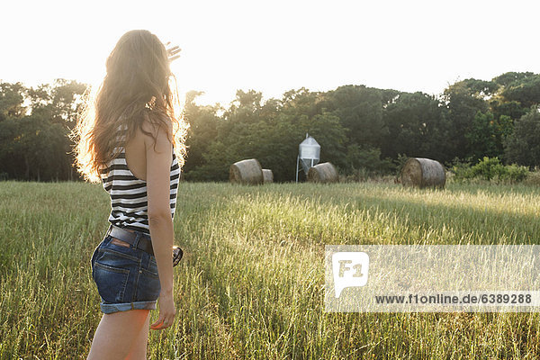 Woman standing in grassy field