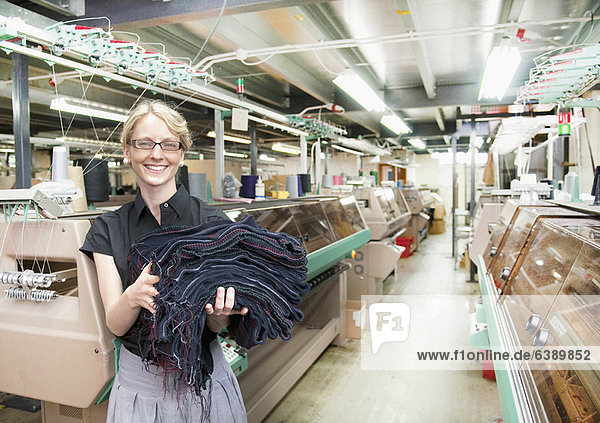 Worker with fabric in garment factory
