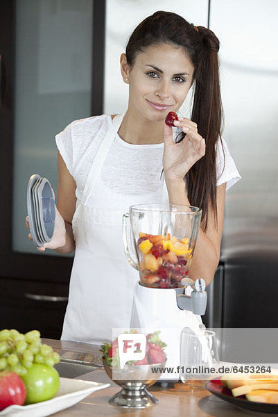 Woman with fruit blender