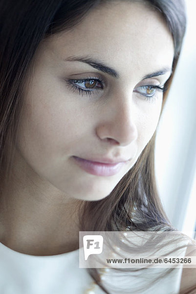 Pensive woman with reflection in her eyes