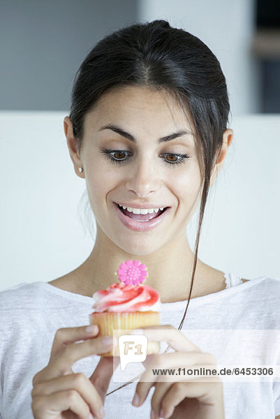 Woman pleased with flower-head cupcake