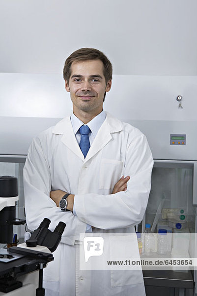 A smiling research technician standing in a research lab