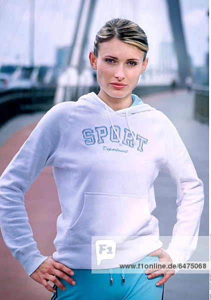 1222725 outdoor bridge day spring young woman blonde 25-30 people white blouse track suit stand smile smiling close up vertical
