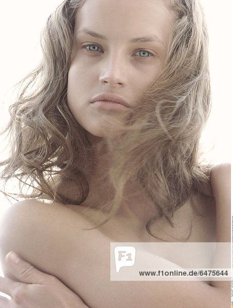 1224796 indoor studio people woman young 20-25 blonde long hair portrait close up sad sadness think dream pose breast breasts bust cover hand hands naked nakedness vertical