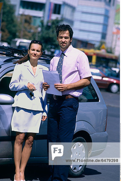 1227313 outdoor day summer spring people young woman man couple beard 25-30 brunette dark haired jacket white dress tie trousers hold document documents stand businessman businesswoman business vertical car fragment