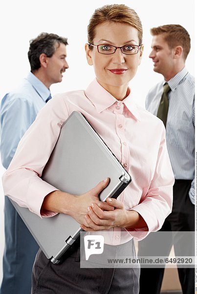 1236601 indoor studio people mature man 45-50 dark haired young men fair haired 25-30 shirt shirts tie woman 35-40 brunette glasses hold personal computer laptop notebook work internet communication business bussineswoman businessman businessmen smile smiling close up vertical