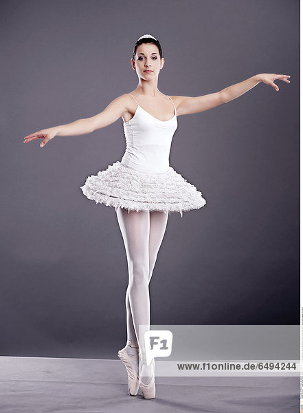 1237008 indoor people woman brunette young 25-30 ballerina ballet dance show representation play vertical dress white vertical stand leggings bun dancer