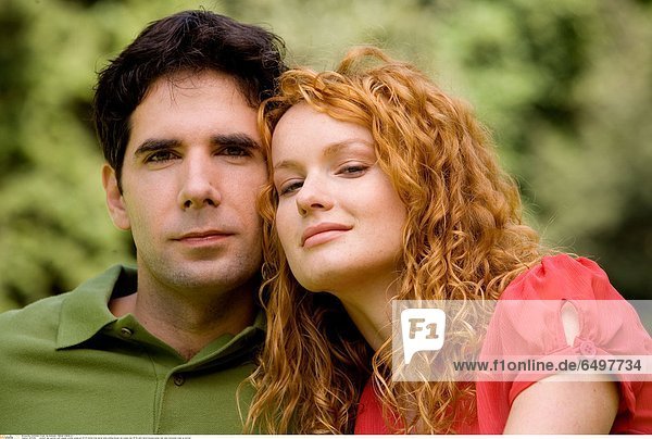 1247255 outdoor day summer park people woman young girl 20-25 blonde long haired smile smiling blouse red couple man 25-30 dark haired blouses green rest relax horizontal close up portrait