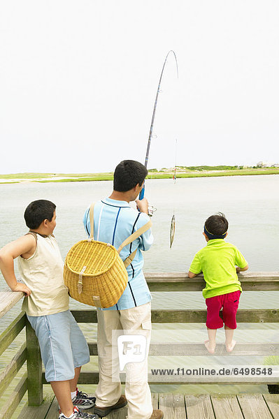 Father fishing with sons