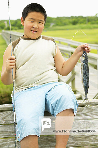 Portrait of boy holding fish