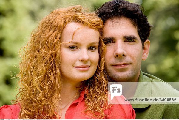 1247259 outdoor day summer park people woman young girl 20-25 blonde long haired smile smiling blouse red couple man 25-30 dark haired blouses green rest relax horizontal close up portrait