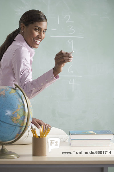 Female teacher at chalkboard