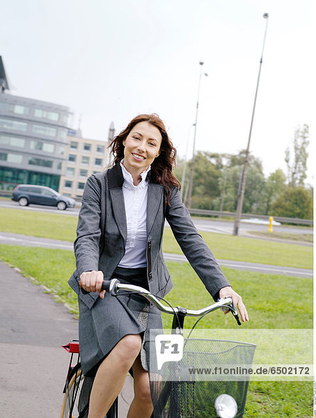 1260141 Woman riding a bicycle.