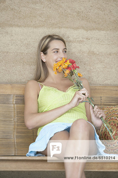 Young Woman smelling flowers
