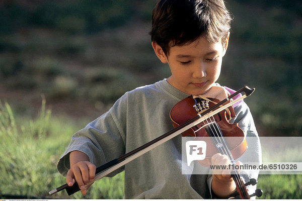 Mandatory Credit: Photo by Gerard Fritz / Rex Features ( 941297bz ) Boy practicing his violin. Various