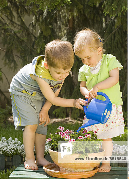 Girl and boy playing in the garden